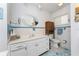 Clean bathroom with white vanity and tiled walls at 2495 Tenth St, Englewood, FL 34224