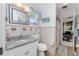 Bathroom with granite countertop, tiled walls, and shower at 2495 Tenth St, Englewood, FL 34224