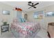 Bedroom with coastal decor, king bed, and ceiling fan at 2495 Tenth St, Englewood, FL 34224