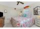 King size bed, coastal decor, and ceiling fan in a bright bedroom at 2495 Tenth St, Englewood, FL 34224