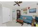 Small bedroom with a sofa, coffee table, and ceiling fan at 2495 Tenth St, Englewood, FL 34224