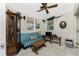 Guest bedroom with sofa, gun cabinet, and ceiling fan at 2495 Tenth St, Englewood, FL 34224