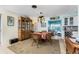 Charming dining area featuring a round table and wooden hutch at 2495 Tenth St, Englewood, FL 34224