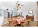 Bright dining area with a round table, wicker chairs, and a view of the kitchen at 2495 Tenth St, Englewood, FL 34224