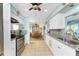 Modern kitchen with white cabinets, granite countertops and stainless steel appliances at 2495 Tenth St, Englewood, FL 34224