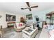 Spacious living room with coastal decor, a wicker chair, and a view of the dining area at 2495 Tenth St, Englewood, FL 34224