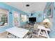 Bright living room with flat-screen TV and access to the outdoors at 2495 Tenth St, Englewood, FL 34224