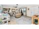 Cozy living room featuring coastal decor, wicker furniture, and a Christmas tree at 2495 Tenth St, Englewood, FL 34224
