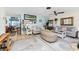 Open living room with coastal decor, and a view into the kitchen and dining area at 2495 Tenth St, Englewood, FL 34224