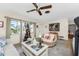 Relaxing living room with wicker furniture, coastal decor, and large windows at 2495 Tenth St, Englewood, FL 34224