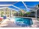 Relaxing screened pool with lounge chair and clear water at 2495 Tenth St, Englewood, FL 34224