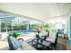 Inviting pool area with screened patio and lounge chairs at 2495 Tenth St, Englewood, FL 34224