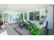 Bright screened porch furnished for relaxing and dining at 2495 Tenth St, Englewood, FL 34224