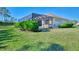 Landscaped backyard with lush greenery and pool at 26852 Faldo Ln, Englewood, FL 34223