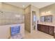 Spa-like Primary bathroom with walk-in shower, toilet, and double vanity at 26852 Faldo Ln, Englewood, FL 34223