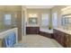 Large Primary bathroom with soaking tub, double vanity, and walk-in shower at 26852 Faldo Ln, Englewood, FL 34223