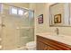 Bathroom with walk-in shower, toilet, and vanity with a granite countertop at 26852 Faldo Ln, Englewood, FL 34223