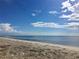 Scenic beach view with calm ocean and white sand at 26852 Faldo Ln, Englewood, FL 34223