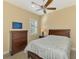 Bedroom with a dresser, queen-size bed and ceiling fan at 26852 Faldo Ln, Englewood, FL 34223