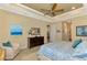 Primary bedroom with king bed, sitting area, and access to bathroom at 26852 Faldo Ln, Englewood, FL 34223