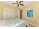 Bedroom with queen bed, ceiling fan, and double door closet at 26852 Faldo Ln, Englewood, FL 34223