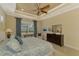 Primary bedroom with king bed, ceiling fan, and dresser at 26852 Faldo Ln, Englewood, FL 34223
