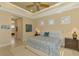 Primary bedroom with king bed, ensuite bathroom access, and sitting area at 26852 Faldo Ln, Englewood, FL 34223