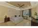 Spacious Primary bedroom with king-size bed, ceiling fan and large windows at 26852 Faldo Ln, Englewood, FL 34223