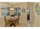 Cozy breakfast nook with wood table and chairs near kitchen at 26852 Faldo Ln, Englewood, FL 34223