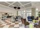 Large clubhouse gathering space with checkerboard floor and comfortable seating at 26852 Faldo Ln, Englewood, FL 34223