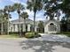 Elegant community clubhouse with ample parking and lush landscaping at 26852 Faldo Ln, Englewood, FL 34223