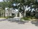 Community clubhouse with covered entryway and landscaping at 26852 Faldo Ln, Englewood, FL 34223