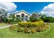 Community clubhouse with manicured landscaping and a welcoming entrance at 26852 Faldo Ln, Englewood, FL 34223