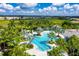 Resort-style pool with lap lanes, cabana, and lush landscaping at 26852 Faldo Ln, Englewood, FL 34223