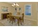 Elegant dining room with a wooden table and chandelier at 26852 Faldo Ln, Englewood, FL 34223