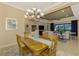 Open concept dining room with a view of the living room and kitchen at 26852 Faldo Ln, Englewood, FL 34223