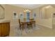 Formal dining room featuring a wood table and neutral decor at 26852 Faldo Ln, Englewood, FL 34223