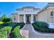 Inviting front entry with brick walkway and landscaping at 26852 Faldo Ln, Englewood, FL 34223