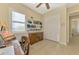 Home office with built-in shelving, desk, and view of hallway at 26852 Faldo Ln, Englewood, FL 34223