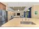 Kitchen with island, sink, and view into the adjacent living room at 26852 Faldo Ln, Englewood, FL 34223