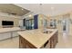 Island kitchen with stainless steel appliances and breakfast bar at 26852 Faldo Ln, Englewood, FL 34223