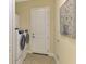 Convenient laundry room with washer, dryer, and overhead cabinets at 26852 Faldo Ln, Englewood, FL 34223