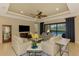 Living room with plenty of natural light and seating area at 26852 Faldo Ln, Englewood, FL 34223