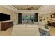 Comfortable living room with large TV and access to pool area at 26852 Faldo Ln, Englewood, FL 34223
