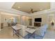 Open concept living room featuring a large TV and comfortable seating at 26852 Faldo Ln, Englewood, FL 34223