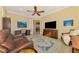 Bright office space with built-in cabinetry and comfortable seating at 26852 Faldo Ln, Englewood, FL 34223