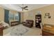 Home office with leather seating, built-in shelving, and large windows at 26852 Faldo Ln, Englewood, FL 34223