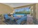 Relaxing covered patio area with seating and view of the pool at 26852 Faldo Ln, Englewood, FL 34223
