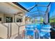Enjoy this screened-in patio with seating and pool view at 26852 Faldo Ln, Englewood, FL 34223
