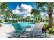 Two lounge chairs with side table overlooking the refreshing pool at 26852 Faldo Ln, Englewood, FL 34223